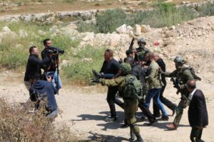Israeli soldiers evacuate wounded Palestinian