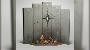 A manger scene juxtaposed against concrete blocks seemingly pierced by a mortar shell: with Christmas looming, Banksy reveals his latest art piece.