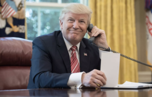 smiling trump on the phone