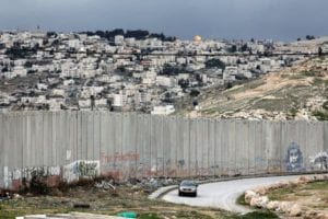 A view of the wall dividing Jerusalem, in background, from the Palestinian town of Abu Dis in the West Bank.