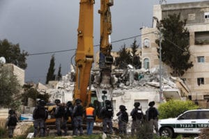 Washington Post covers for many of Israel's human rights abuses. Pictured: An Israeli-run team along with Israeli soldiers and bulldozers demolish the house owned by Hatem Abu Rayaleh, a disabled Palestinian, in East Jerusalem on March 1, 2021.