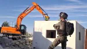 Israeli soldier watches during the demolition of a Palestinian home in the village of Al-Walajah, November 9, 2021. From B'Tselem video