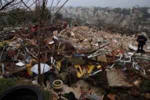 A person walks on the ruins of a Palestinian house demolished by Israeli forces, in Sheikh Jarrah neighborhood on January 19, 2022. - Israeli police destroyed the home of a Palestinian family in the sensitive east Jerusalem neighbourhood of Sheikh Jarrah early Wednesday morning, an AFP photographer said.<br />