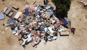 Belongings from a Palestinian family house are scattered on the ground, after the house was demolished earlier that day by Israeli forces in the village of Umm Al-Khair in the occupied West Bank, on 9 August 2016