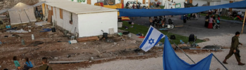 Israeli settlers and soldiers gather at the recently established wildcat outpost of Eviatar near the West Bank city of Nablus, July 2021.