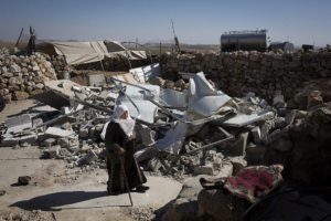 A Palestinian woman next to demolished home after they were torn down by Israeli bulldozers in the village of Khirbet al-Halawah, in Firing Zone 918, South Hebron, Hills, West Bank, February 3, 2016.