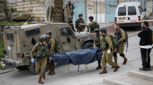 Does Mike Pence know this story? Israeli soldiers the body of a Palestinian man who had stabbed a soldier in the West Bank city of Hebron, March 24, 2016. The man was incapacitated and posed no threat when a soldier walked up and shot him in the head at point blank range. Israel's prime minister, Benjamin Netanyahu, praised the act. The soldier served a nine-month sentence for killing the Palestinian.