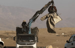 Workers dismantle tents during a demolition operation led by Israeli security forces of Khirbet Humsah