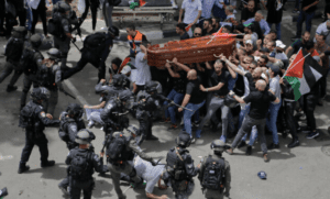 Israeli police confront mourners as they carry the casket of slain Shireen Abu Akleh, May 13, 2022.