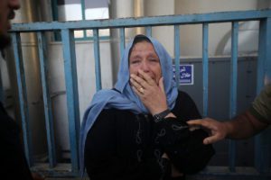 A Palestinian woman mourns outside a morgue following an Israeli air strike in Gaza, August 5, 2022.