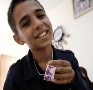 Jawabra wears a photograph of Ibrahim al-Nabulsi in a pendant dangling from a chain around his neck.