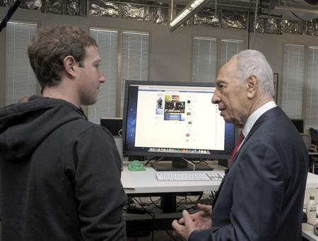 Israeli President Shimon Peres launches his Facebook page with the company's CEO Mark Zuckerberg, March 6, 2012.
