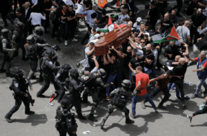 Israeli police attacking mourners carrying the casket of Shireen Abu Akleh in East Jerusalem on Friday, May 13, 2022