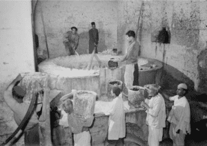 NABLUS - The Soap Factory. The boiling pot liquid soap being carried to stock room, 1940 (Matson collection)