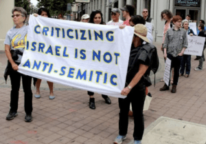 banner says criticizing israel is not antisemitic