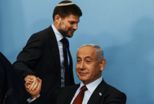 Israeli Finance Minister Bezalel Smotrich shakes the hand of Israeli Prime Minister Benjamin Netanyahu at the Prime Minister's office in Jerusalem, Jan. 25, 2023.
