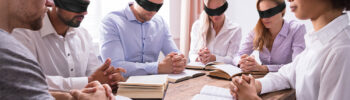 People with blindfolds on conduct a Bible study