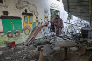 A woman stands amid the rubble at a kindergarten hit by an Israeli bombing in Rafah in the southern Gaza Strip.