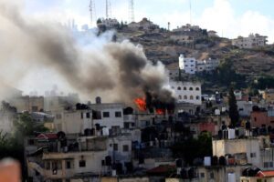 Smoke rises in Jenin during an Israeli raid that killed 7