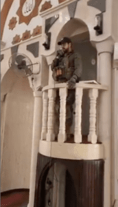 Israeli army officers singing Jewish prayers into the loudspeaker in a local mosque during a raid in Jenin