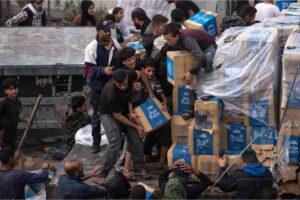 Desperate Palestinians seize boxes of water from aid truck