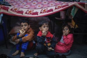 Palestinian children take shelter at a school run by the United Nations Relief and Works Agency for Palestine Refugees in the Near East (UNRWA), in the city of Khan Yunis, in southern Gaza, on November 15. Displaced civilians told CNN the arrival of winter in Gaza further threatens their survival.
