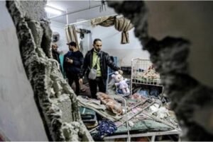 People inspect the damage in a room in Nasser Hospital, Khan Younis, after and Israeli strike