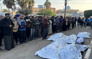 Relatives perform funeral prayers for five members of the Sabah family, killed in Israeli strikes in Deir el-Balah, on Saturday