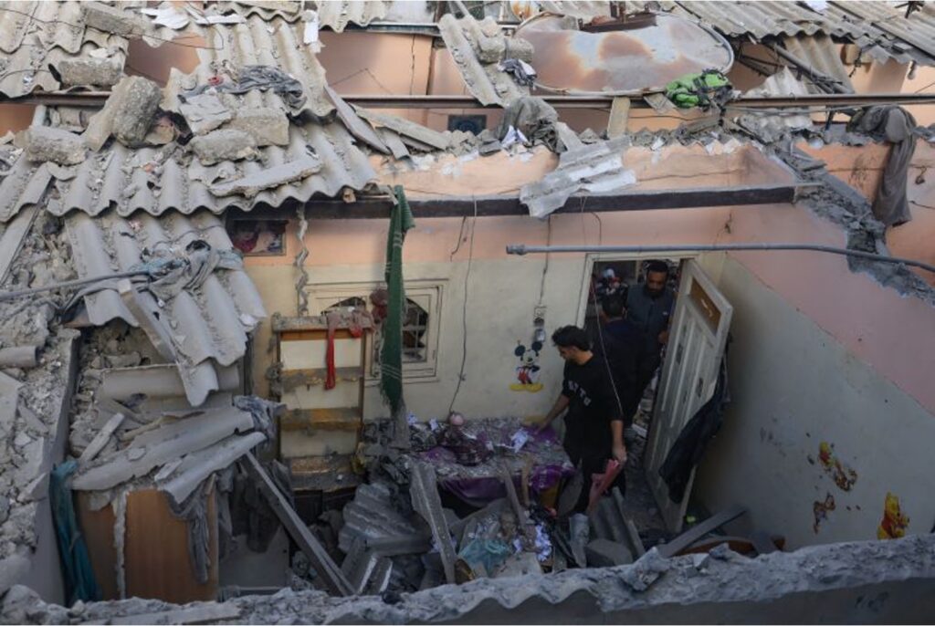 Palestinians check the damage of a house destroyed in an Israeli strike on Khan Younis, December 1, 2023