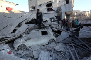 Palestinians inspect the damage in their neighbourhood