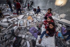Palestinian children sit rubble of what was once their home in Rafah, in the southern Gaza Strip, on December 29, 2023. Rafah was a so-called ‘safe zone’ but is now under regular attack by Israel