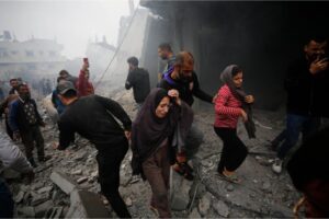 Residents sift through the rubble of an Israeli attack in Deir el-Balah, Gaza, December 5