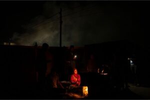 Palestinians displaced by the Israeli bombardment of the Gaza Strip cook at the makeshift tent camp in the Muwasi area on Sunday, December 31, 2023