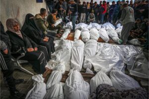 Palestinians wait to receive the bodies of their relatives who were killed in an Israeli airstrike, at Al-Najjar Hospital, southern Gaza Strip, December 7, 2023.