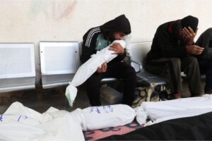 A man kisses the body of a Palestinian child killed in an Israeli strike, amid the ongoing conflict between Israel and the Palestinian Islamist group Hamas, at Abu Yousef al-Najjar hospital, in Rafah, Saturday