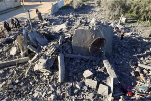 People inspect the damage following Israeli bombardment on Rafah, Saturday