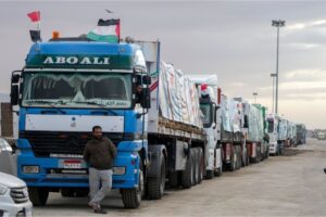 Trucks carrying humanitarian aid line up at the Rafah crossing near Gaza’s border with Egypt