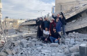The family of the martyr Nasr Al-Qawasmeh takes memorial photos over the rubble of their house that was blown up by the occupation in Hebron.