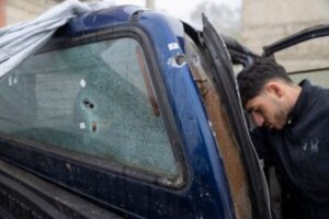 A youth inspects the truck in which Tawfiq Abdel Jabbar was killed.