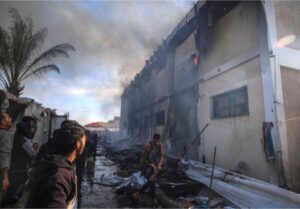 Palestinians try to extinguish a fire at an UNRWA vocational training centre after being targeted by Israeli tank shell in Khan Younis, Wednesday, January 24, 2024
