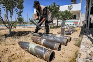 A Hamas explosives expert at a local police precinct in Khan Younis in 2021 laying out unexploded projectiles from the aftermath of a conflict with Israel that May.