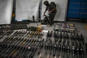 An Israeli soldier standing near armaments during an official media tour organized by the military where it displayed a variety of weapons recovered from areas hit by the Hamas militants during their Oct. 7 attack.