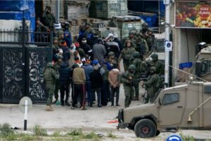 Israeli security forces arrest Palestinian men during a military raid in Nur Shams refugee camp in Tulkarem, West Bank on January 3, 2024
