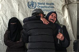 Palestinians mourn after identifying the bodies of relatives killed in overnight Israeli bombardment on the southern Gaza Strip, at Al-Najjar hospital in Rafah, Saturday