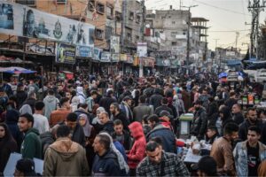 Palestinians who are taking shelter in Rafah shop in an overcrowded market to meet some of their needs, on Sunday, February 11