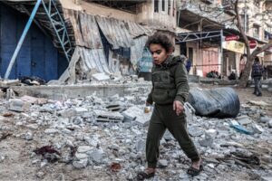 A girl walks through rubble in an area hit by Israeli bombardment in Rafah in the southern Gaza Strip on February 7, 2024