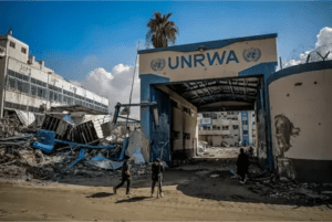 Palestinians examine the damage to the UNRWA buildings in Gaza City.