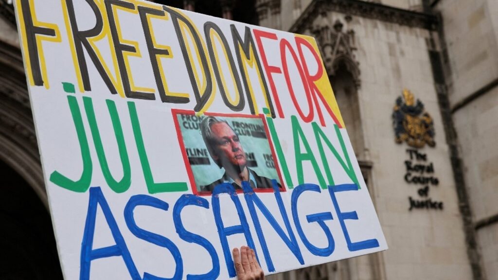 A protester holds a placard calling for the release of Wikileaks founder Julian Assange outside of Britain’s High Court in central London, on 21 February 2024