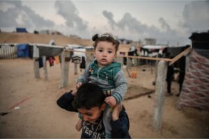 Palestinian children play in a makeshift tent camp in Rafah