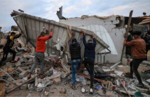 People look for survivors in the rubble of the Abu Saleh family home in Rafah in the southern Gaza Strip, February 5, 2024